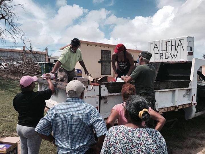 Line of residents receiving supplies from Alpha CREW truck in Vieques