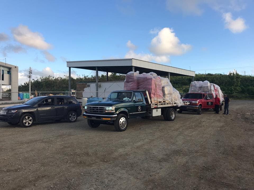 Alpha CREW truck convoy loaded with supply pallets at staging area